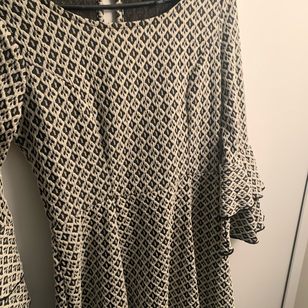 off white and black bell sleeved dress
